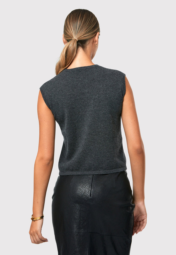 The Marlena Grey Cashmere Sweater-Vest is a sleeveless round-neck top that offers versatile styling options. Wear it as a simple underpinning for the matching ballet wrap to complete a coordinated look. Alternatively, layer it as a sweater vest over your favorite crisp white shirts for a stylish and contemporary outfit. Made from luxurious cashmere, the Marlena Sweater-Vest adds an extra layer of comfort and sophistication to your wardrobe.