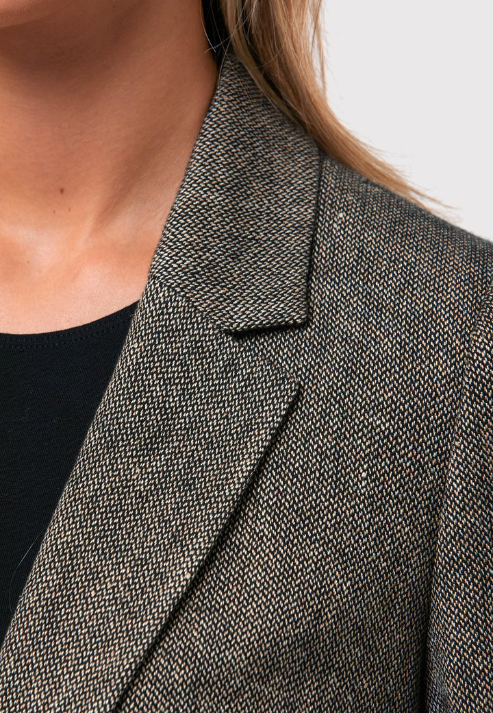 Step into timeless sophistication with the Marlowe Tweed Jacket. Meticulously crafted from a refined blend of black and cream tweed, this exquisite garment showcases an tidy collar and revere, complemented by a triple button fastening. Its flawless tailoring and meticulous attention to every aspect make it a chic selection that effortlessly enhances your wardrobe. 