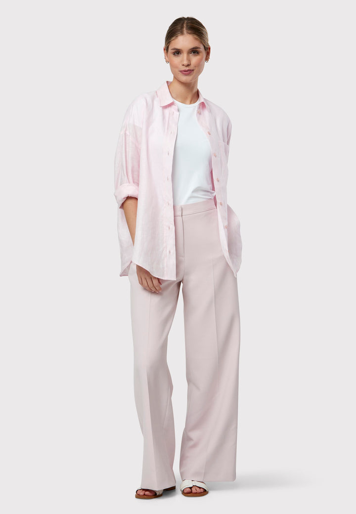 Meet the Naomi Soft Pink Trousers, designed for a modern and elegant look. These wide-leg trousers offer a high waist and flat front for a sleek appearance. Their soft pink shade makes them a versatile staple for any wardrobe, perfect for various occasions. Pair them with the matching Darcie Soft Pink Tux Jacket for a sophisticated look.