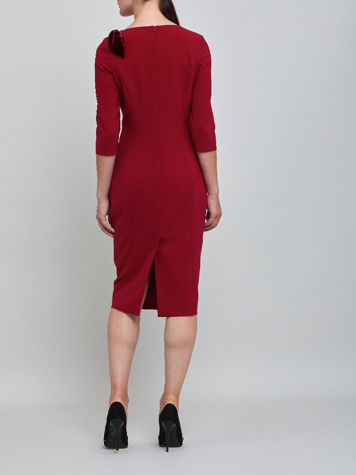 Natara, the perfect occasion dress. Crafted in a tricotine fabric with a hint of stretch. A body-skimming silhouette with slash neck, velvet bow detail and a pencil skirt the dress falls to mid-calf. Wear her out to cocktails with the girls, date night or a special winter wedding!