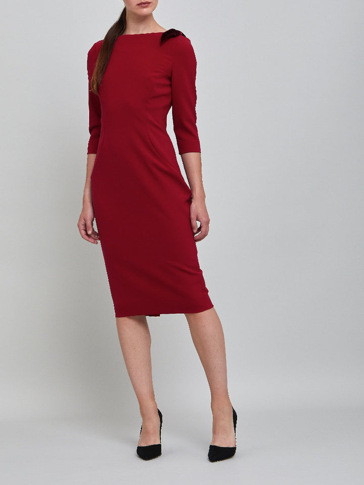 Natara, the perfect occasion dress. Crafted in a tricotine fabric with a hint of stretch. A body-skimming silhouette with slash neck, velvet bow detail and a pencil skirt the dress falls to mid-calf. Wear her out to cocktails with the girls, date night or a special winter wedding!