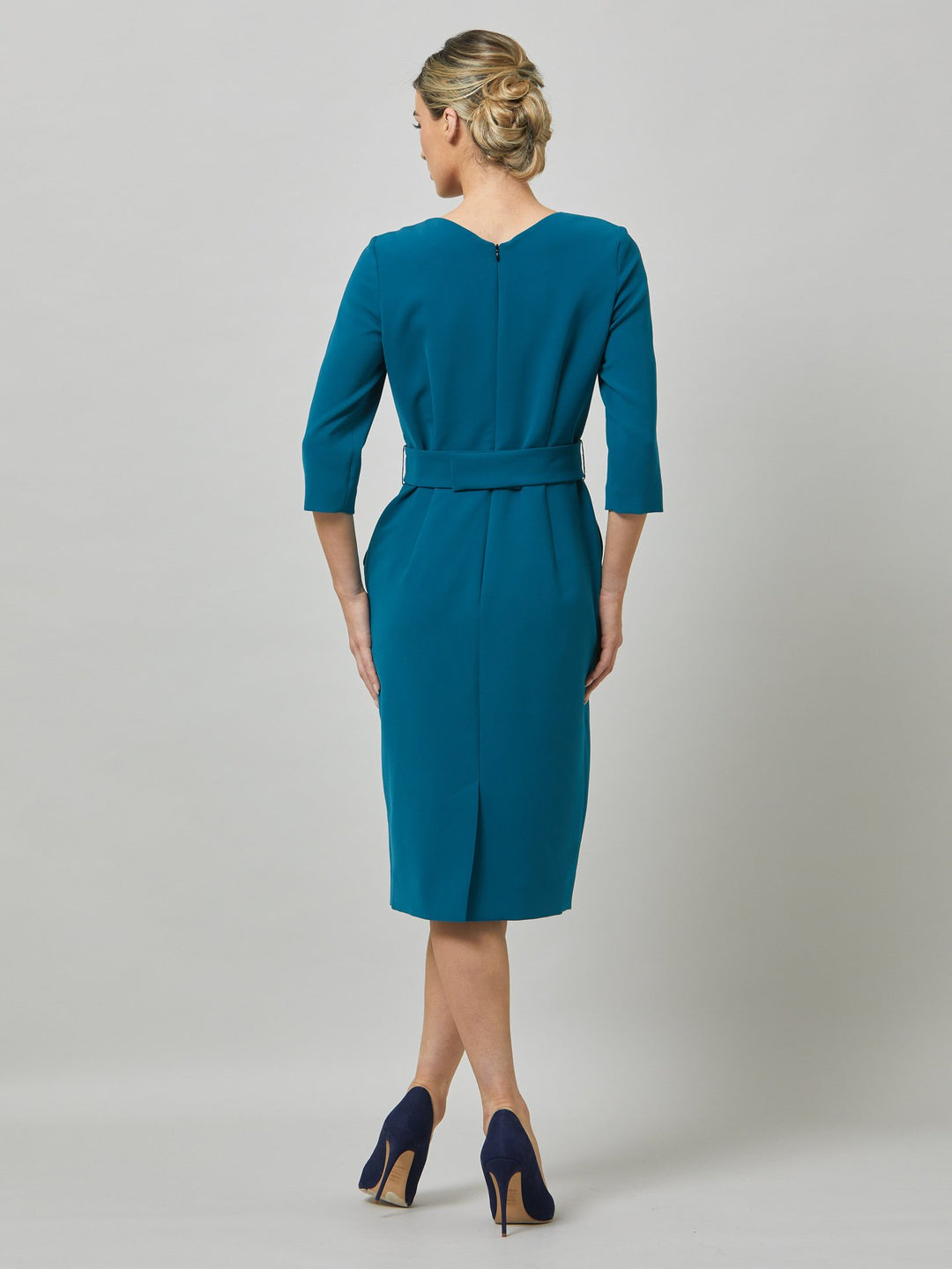 Nina is a fresh take on one of our key silhouettes. Note the softly pleated neckline and the elegant silhouette which hugs the frame around the hips and thighs for a flattering wear. Skirt falls to below the knee, fitted to the waist with handy pockets and detachable belt. Crafted in our signature crepe with a hint of stretch in atlantic teal. the perfect desk to dinner dress.