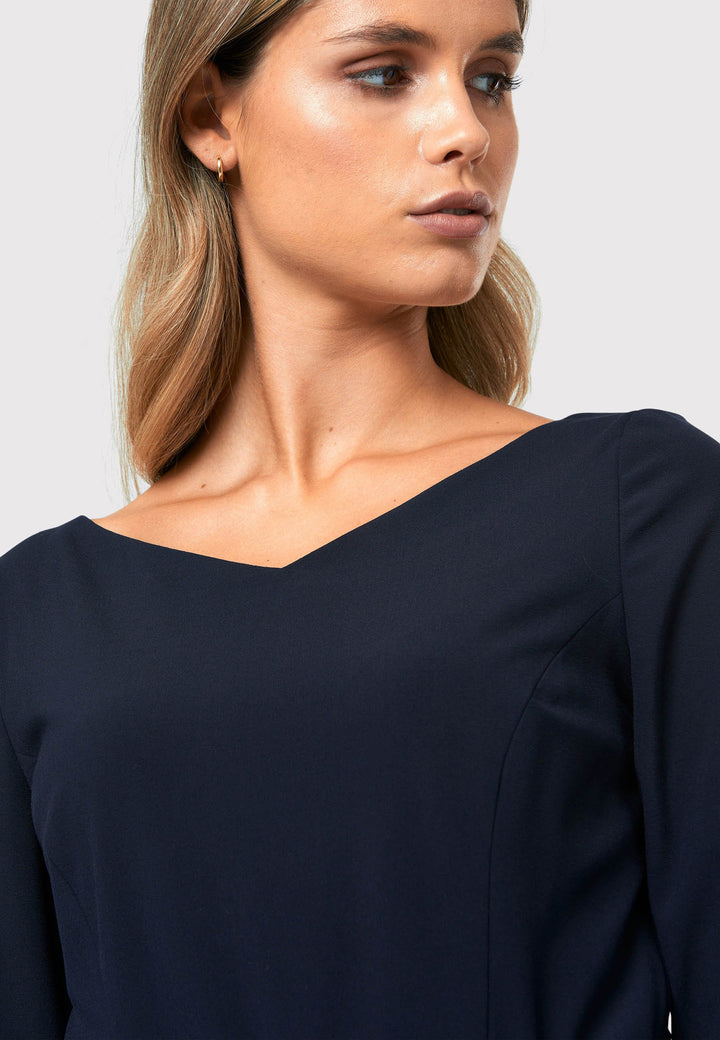 Step into elegance with the Odell Dark Navy Dress, a beautifully tailored and timeless piece. This dress features a detachable belt, fit and flare skirt, and an asymmetrical dipped hem. The wide V-neckline adds sophistication, while the hint of stretch ensures comfort and ease of movement. Whether you're attending a wedding, playing the role of the mother of the bride, or heading to the races, the Odell Dark Navy Dress is the perfect choice for a memorable occasion.