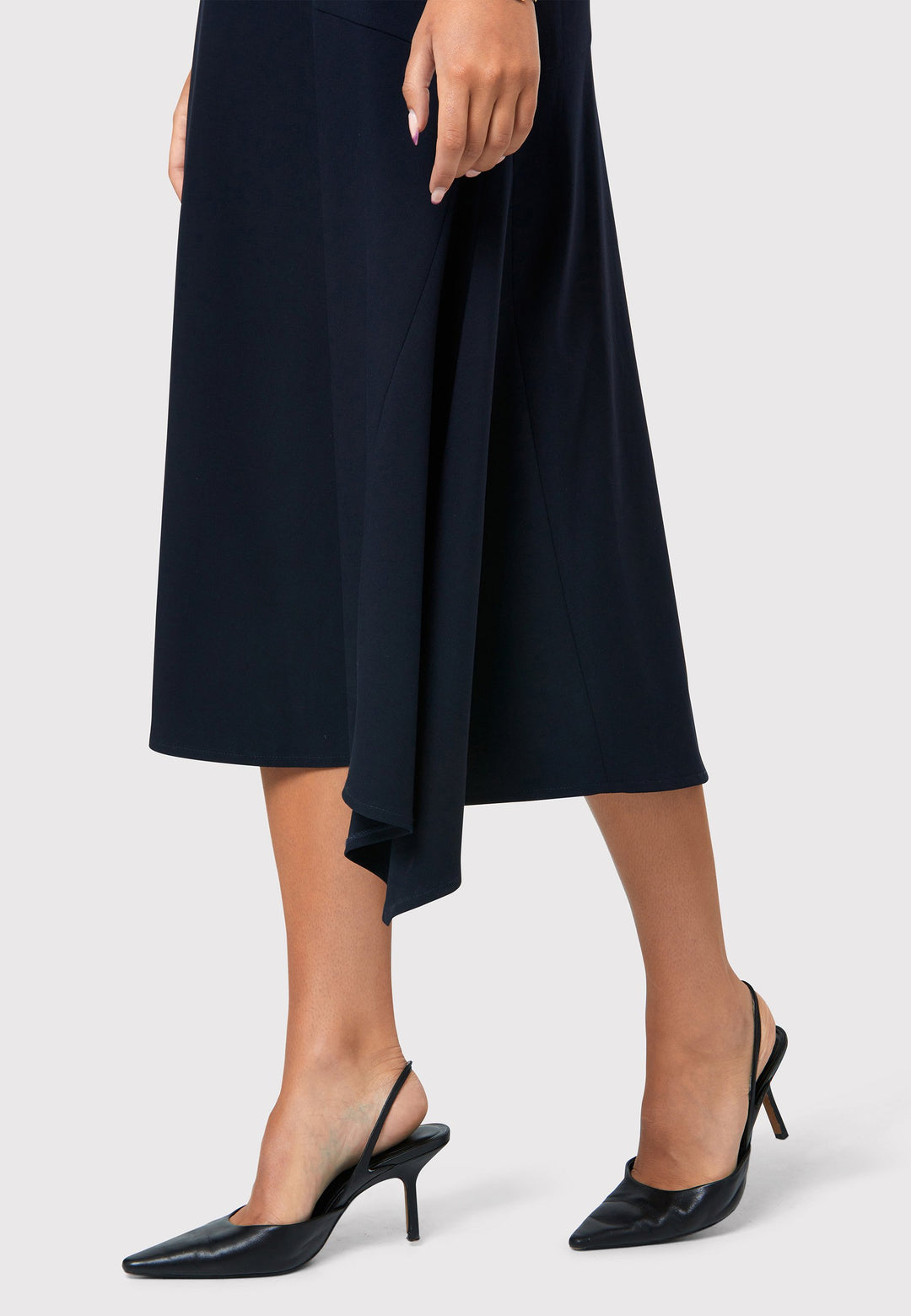 Step into elegance with the Odell Dark Navy Dress, a beautifully tailored and timeless piece. This dress features a detachable belt, fit and flare skirt, and an asymmetrical dipped hem. The wide V-neckline adds sophistication, while the hint of stretch ensures comfort and ease of movement. Whether you're attending a wedding, playing the role of the mother of the bride, or heading to the races, the Odell Dark Navy Dress is the perfect choice for a memorable occasion.