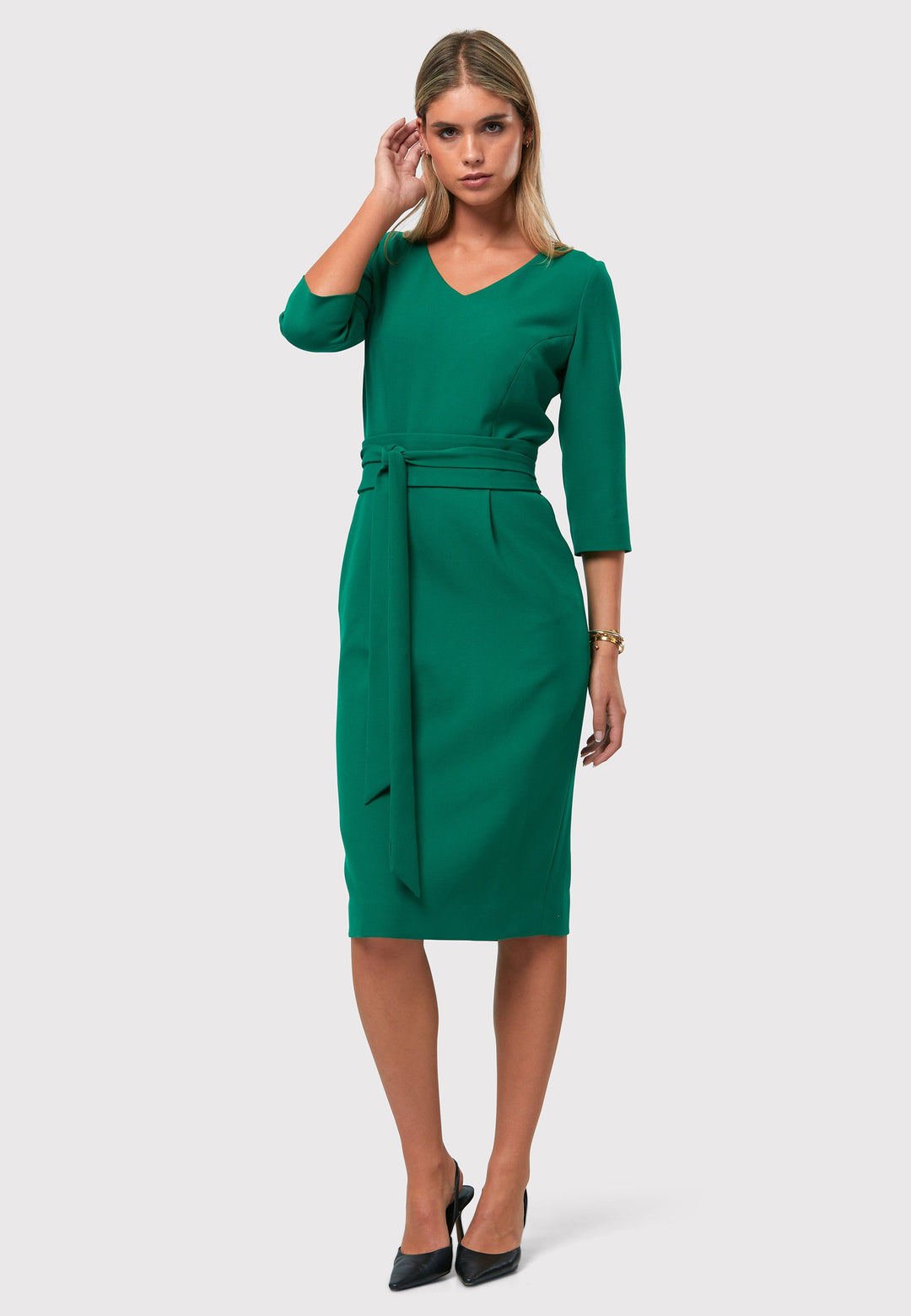 Introducing the Ophelia Dark Emerald Green Dress, a timeless and impeccably tailored silhouette. This expertly crafted dress features a form-flattering design with convenient pockets, a detachable belt, and a pencil skirt that falls to a chic mid-calf length. The sophisticated V-neckline adds an elegant touch to the overall look. Crafted from sustainably sourced fibers with a hint of stretch, this dress ensures both comfort and ease of movement. 