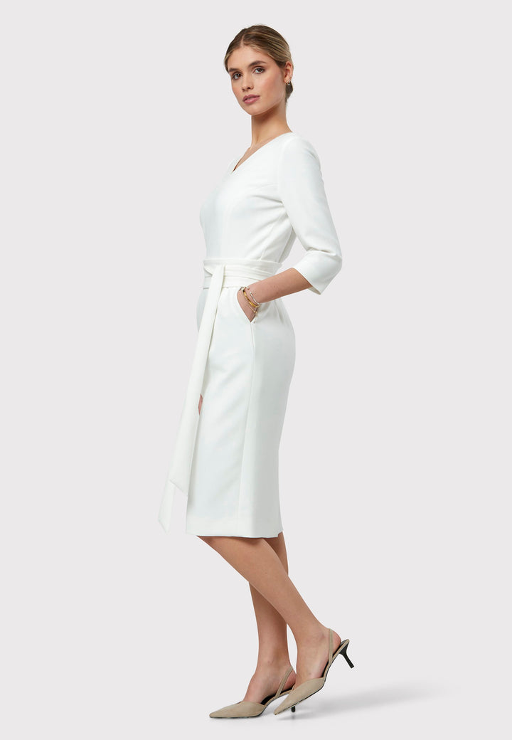 Meet Ophelia, a figure-flattering dress with pockets, a detachable belt, and a mid-calf pencil skirt. The refined V-neckline adds an elegant touch to this piece. Crafted from our signature tricotine with a hint of stretch for comfort and movement, it's perfect on its own or paired with the matching Obi belt. Ophelia is your go-to dress for summer events or race day elegance.