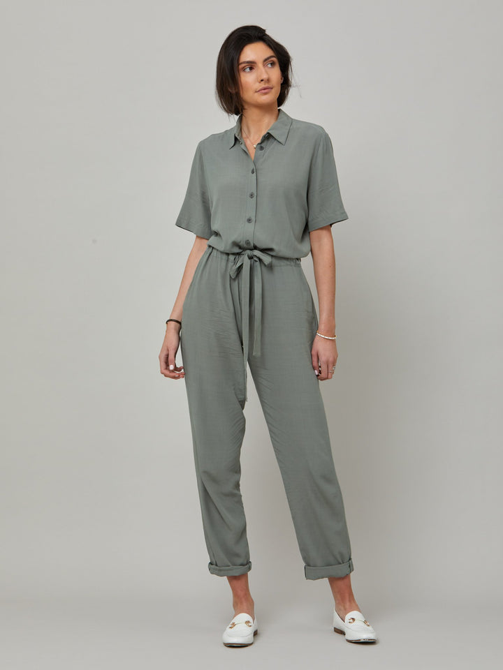 Peggy, a slim-leg jumpsuit in a soft lichen green viscose crepe. Offers a neat button-up collar, belt with a channel and short sleeves. From garden parties to holiday lunches this one-piece has you covered. Designed in Ireland by Helen McAlinden. Made in Europe. Free shipping to the EU & UK.