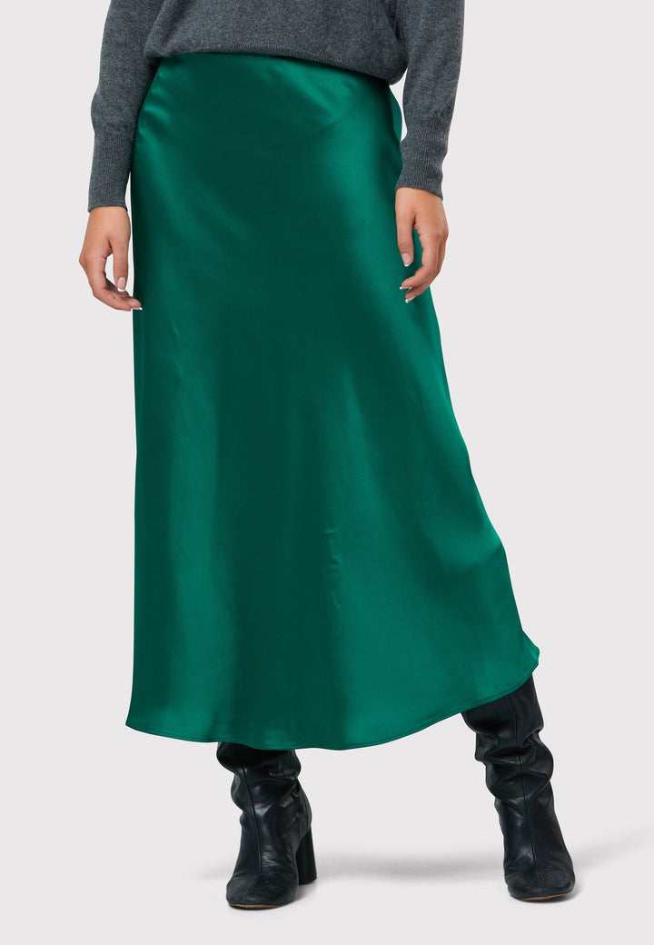 Indulge in the Peyton Dark Emerald Green Satin Skirt, a stunning mid-calf length piece. With its form-flattering high-waisted silhouette and luxurious dark emerald green satin fabric, this skirt exudes elegance. The side seam zip ensures a seamless fit. Perfect for special occasions or elevated everyday wear, it captivates with its timeless appeal, leaving a lasting impression wherever you go.