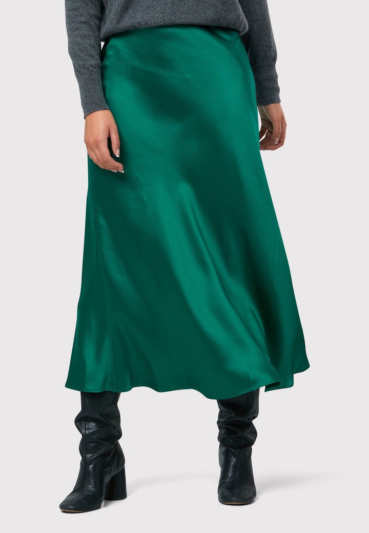 Indulge in the Peyton Dark Emerald Green Satin Skirt, a stunning mid-calf length piece. With its form-flattering high-waisted silhouette and luxurious dark emerald green satin fabric, this skirt exudes elegance. The side seam zip ensures a seamless fit. Perfect for special occasions or elevated everyday wear, it captivates with its timeless appeal, leaving a lasting impression wherever you go.