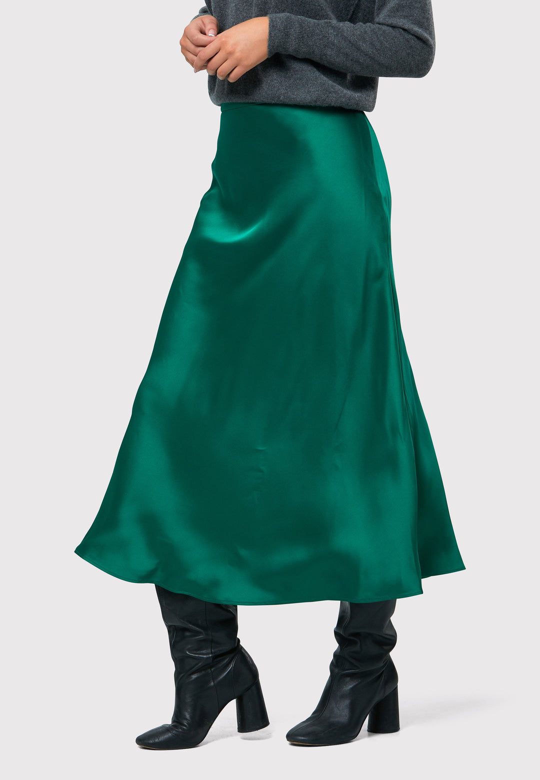 Indulge in the Peyton Dark Emerald Green Satin Skirt, a stunning mid-calf length piece. With its form-flattering high-waisted silhouette and luxurious dark emerald green satin fabric, this skirt exudes elegance. The side seam zip ensures a seamless fit. Perfect for special occasions or elevated everyday wear, it captivates with its timeless appeal, leaving a lasting impression wherever you go.