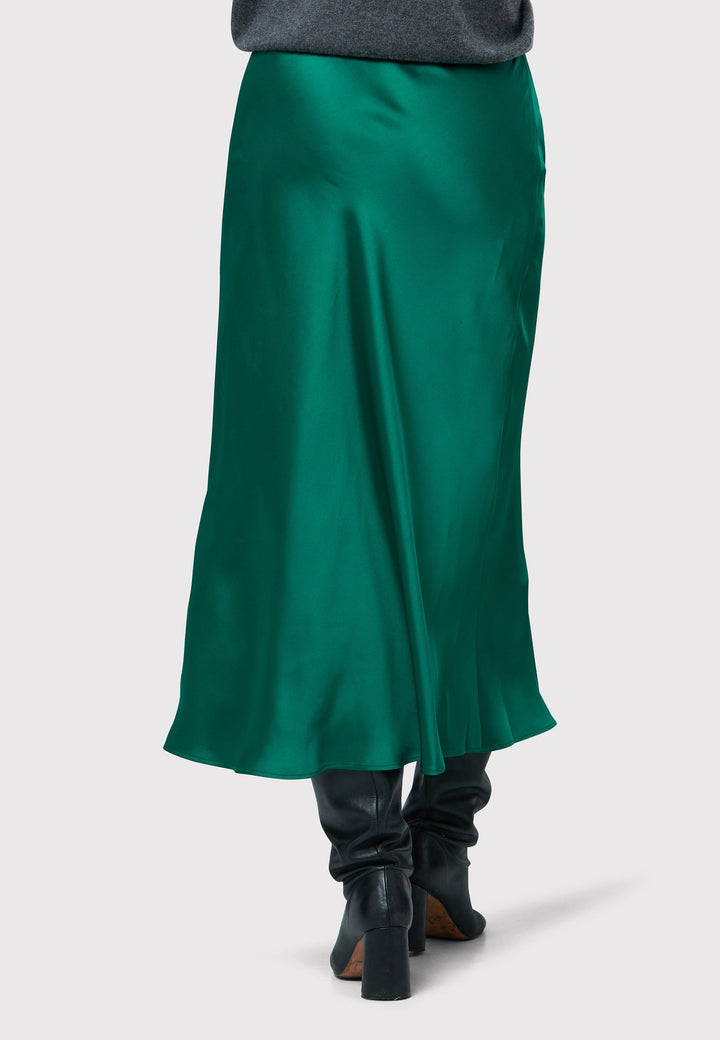 Indulge in the Peyton Dark Emerald Green Satin Skirt, a stunning mid-calf length piece. With its form-flattering high-waisted silhouette and luxurious dark emerald green satin fabric, this skirt exudes elegance. The side seam zip ensures a seamless fit. Perfect for special occasions or elevated everyday wear, it captivates with its timeless appeal, leaving a lasting impression wherever you go.