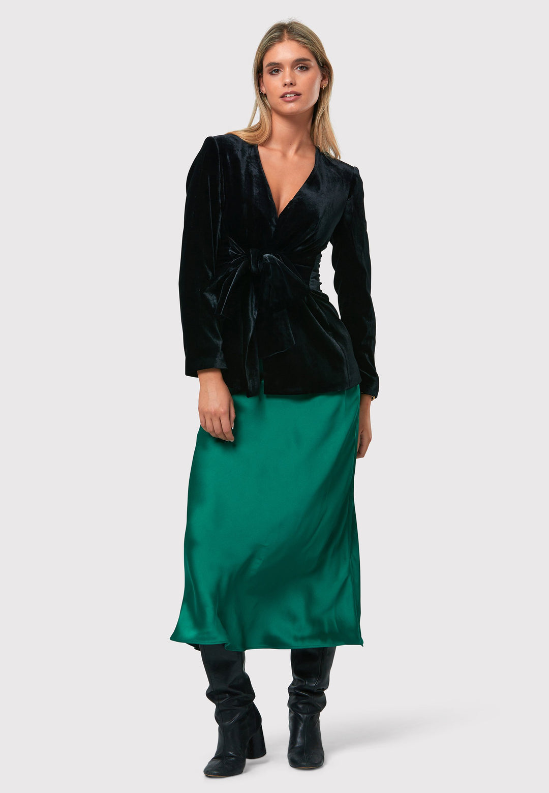 Indulge in the Peyton Dark Emerald Green Satin Skirt, a stunning mid-calf length piece. With its form-flattering high-waisted silhouette and luxurious dark emerald green satin fabric, this skirt exudes elegance. The side seam zip ensures a seamless fit. Perfect for special occasions or elevated everyday wear, it captivates with its timeless appeal, leaving a lasting impression wherever you go.