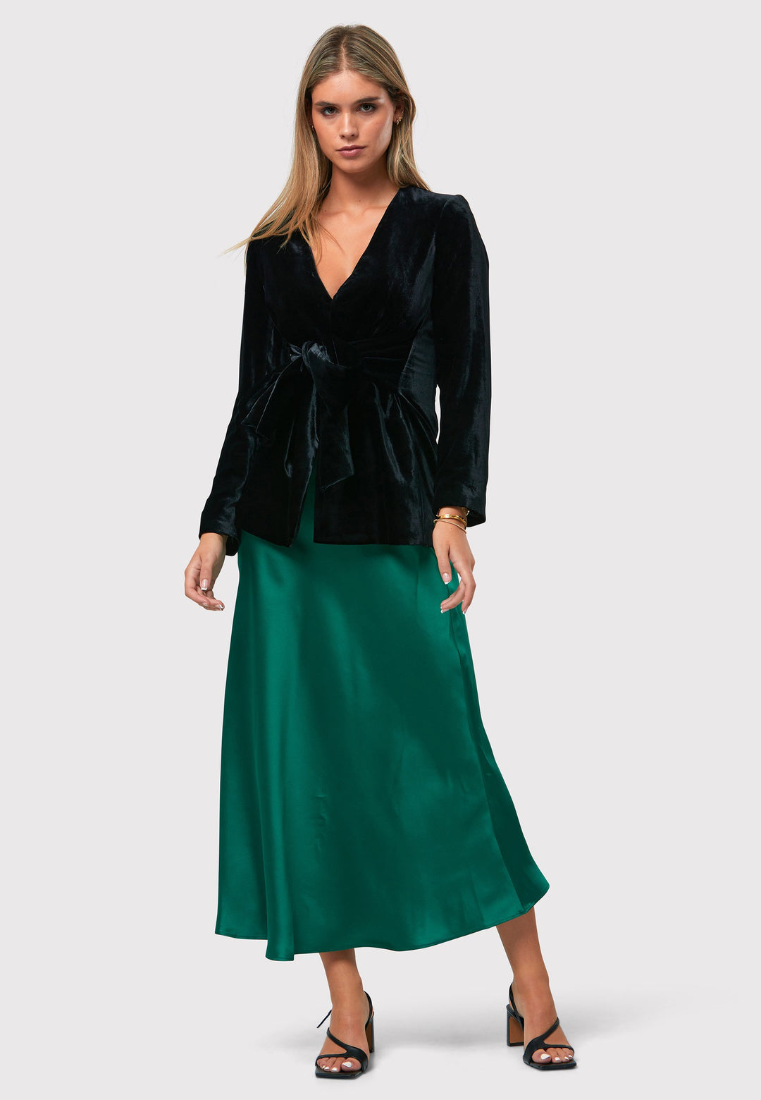 Indulge in the Peyton Dark Emerald Green Satin Skirt, a stunning mid-calf length piece. With its form-flattering high-waisted silhouette and luxurious dark emerald green satin fabric, this skirt exudes elegance. The side seam zip ensures a seamless fit. Perfect for special occasions or elevated everyday wear, it captivates with its timeless appeal, leaving a lasting impression wherever you go.