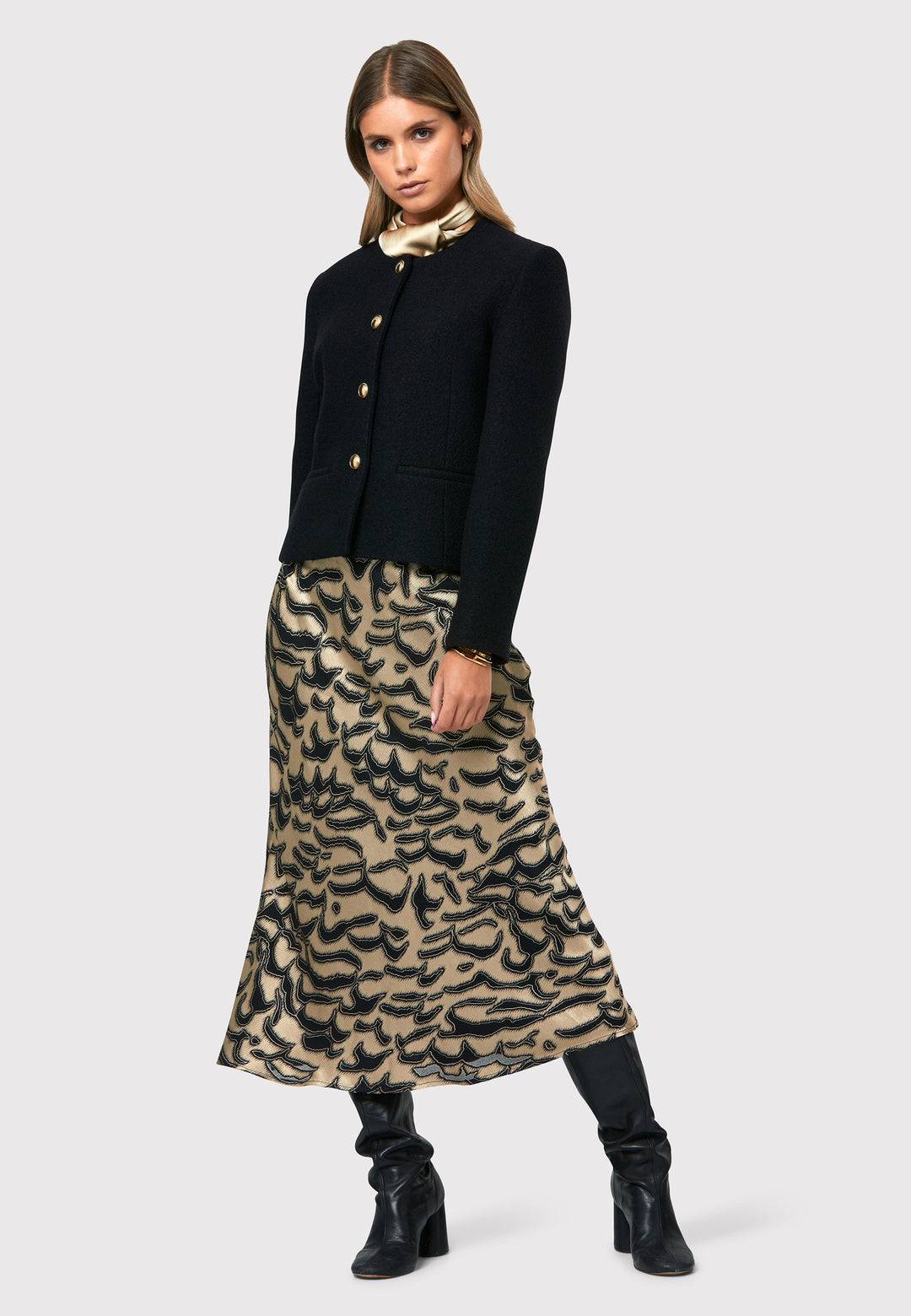Indulge in the Peyton Devore Bias Skirt, a stylish mid-calf length skirt designed to flatter your figure. With a high-waisted silhouette and a striking black and gold devore patterned satin, it adds a touch of glamour to your look. The form-flattering cut enhances your silhouette, while the side seam zip ensures easy and comfortable wearing. Versatile and chic, the Peyton Devore Bias Skirt is your go-to choice for various occasions, effortlessly elevating your style with a touch of sophistication.