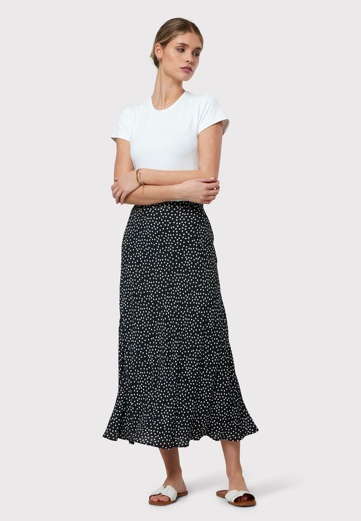 Experience the charm of the Peyton Navy and White Polka Dot Skirt, beautifully crafted with a graceful bias cut for an elegant drape. This mid-calf length design features a flattering high-waisted silhouette in classic navy and white polka dot viscose crepe fabric, echoing 30's glamour.