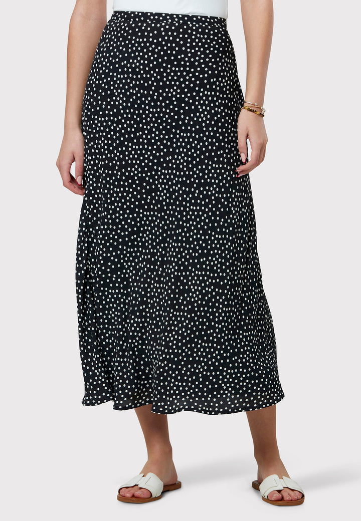 Experience the charm of the Peyton Navy and White Polka Dot Skirt, beautifully crafted with a graceful bias cut for an elegant drape. This mid-calf length design features a flattering high-waisted silhouette in classic navy and white polka dot viscose crepe fabric, echoing 30's glamour.