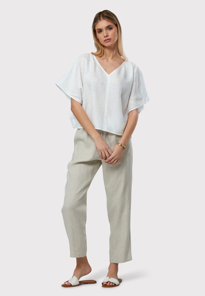 Quinn White Linen Shirt offers an effortless warm-weather look, crafted from breathable pure linen with a flattering v-neck design. Its easy fit ensures summer comfort, complemented by subtle pleat detailing on the back hem for added style.