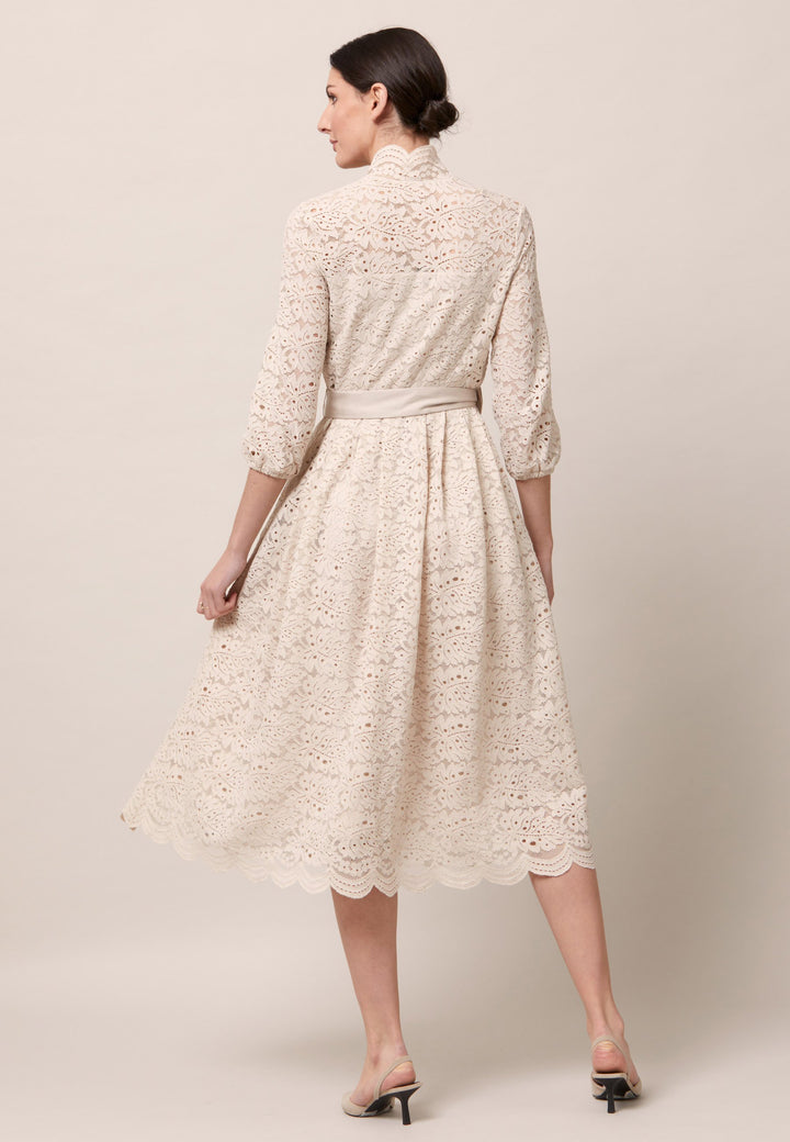 Add a touch of Romance to your life with the Sandra dress. Crafted in a warm oyster tone lace. The silhouette is rooted in simplicity with a fitted bodice and flared softly pleated skirt. Crafted with a pretty scalloped neckline and scalloped hem that falls to mid-calf. Wear to Party, to dinner or for that special wedding. Style with heels for a sophisticated occasion.
