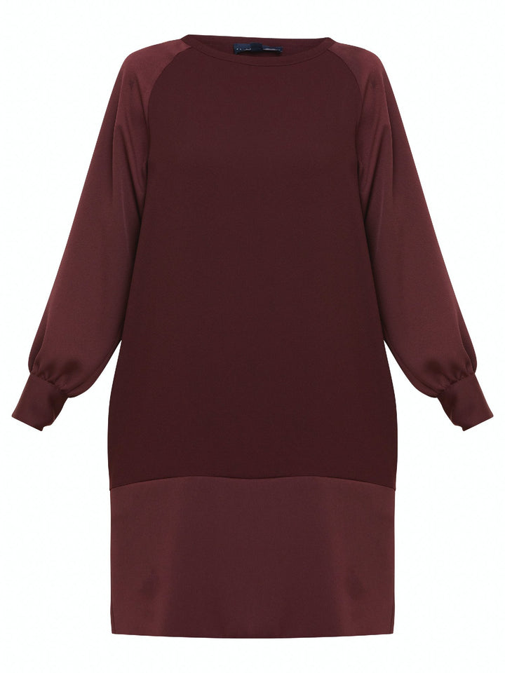 Sarah, a simple easy-fit shift dress. Crafted in a satin back crepe in rich burgundy. Features a satin raglan sleeve & a deep satin band at the hem which adds elegance to this versatile piece. Offers handy side seam pockets for added comfort and functionality. A fresh take on occasion wear.