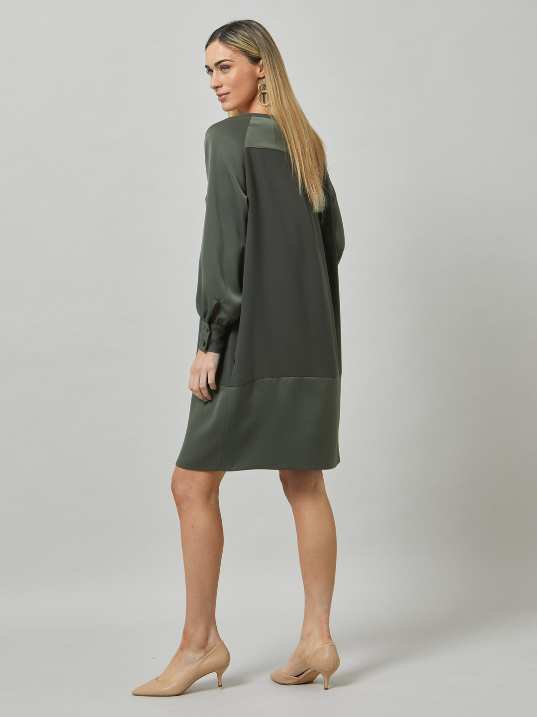Introducing Sarah, a chic and effortlessly stylish shift dress that brings a fresh perspective to occasion wear. Crafted from luxurious olive satin back crepe, it offers a simple and easy-fit silhouette. The satin raglan sleeves add a touch of sophistication, while the deep satin band at the hem enhances the overall elegance. With convenient side seam pockets, Sarah provides both comfort and functionality. Embrace the versatility and timeless appeal of this dress, perfect for various occasions.