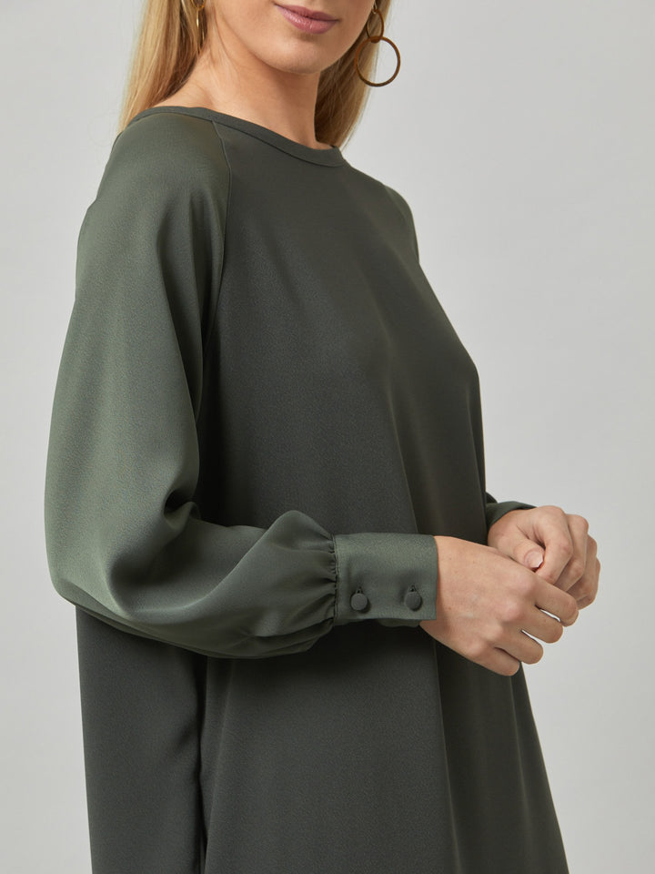 Introducing Sarah, a chic and effortlessly stylish shift dress that brings a fresh perspective to occasion wear. Crafted from luxurious olive satin back crepe, it offers a simple and easy-fit silhouette. The satin raglan sleeves add a touch of sophistication, while the deep satin band at the hem enhances the overall elegance. With convenient side seam pockets, Sarah provides both comfort and functionality. Embrace the versatility and timeless appeal of this dress, perfect for various occasions.