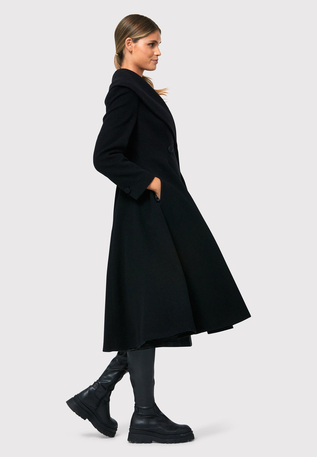 Step into 50s glamour with the Scarlett Black Coat, a captivating outerwear crafted from a wool and cashmere blend melton. This fit & flare silhouette boasts an oversized shawl collar, cinched waist, and convenient side seam pockets. Perfect for winter weddings or any occasion where you desire a touch of glamour and warmth, the Scarlett Black Coat combines style and functionality in one stunning piece.