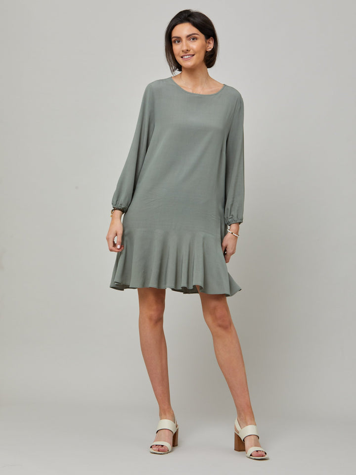 Sheila, a great everyday dress. Crafted in our fluid lichen green viscose crepe. A flirty knee-grazing shift dress with a soft elasticated cuff sleeve that falls to a deep frill hem with a jewel neckline and key-hole back detail. For everyday comfort style with trainers. Elevate your mood with this fun piece.