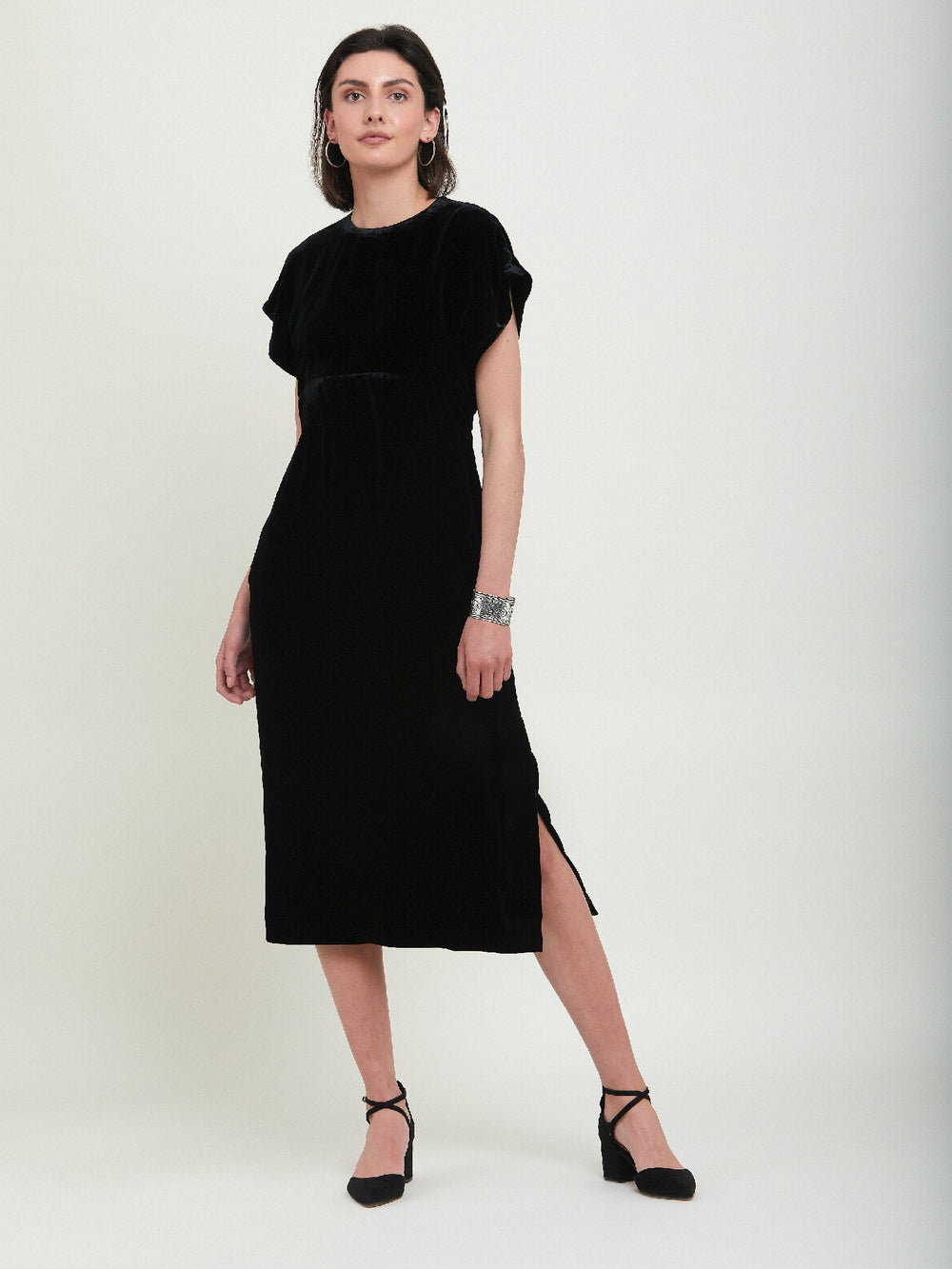 Occasionwear modernized. Meet the Shiv Black dress in Luxurious fluid velvet. An easy-fitting silhouette with side seam pockets falls to the mid-calf & features a side slit, dropped sleeves, and an elegant key-hole back neck detail. Attending a winter wedding? This is the dress for you.