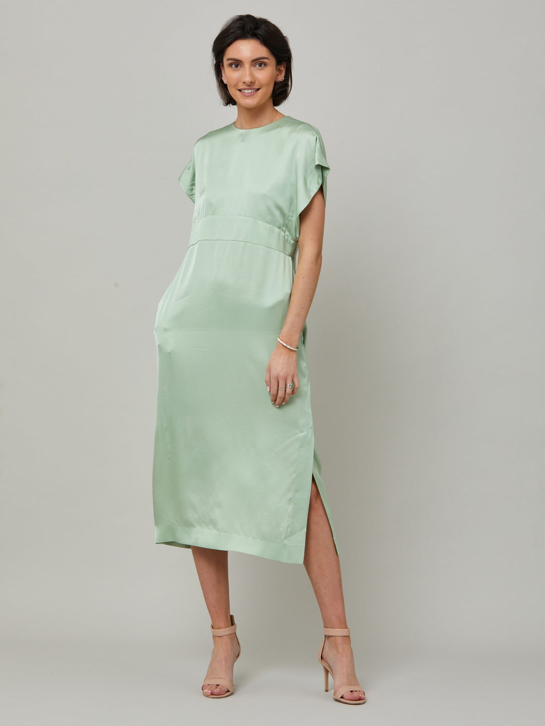 Classic occasion wear, modernized. Meet the Shiv dress in luxurious tea green satin viscose. An easy-fitting silhouette that falls to the mid-calf and features side slit, pockets, and an elegant key-hole back neck detail. . Attending a summer wedding? Mother of the bride? Heading to the races? This is the dress for you. Designed in Ireland by Helen McAlinden. Made in Europe. Free shipping to the EU & UK.