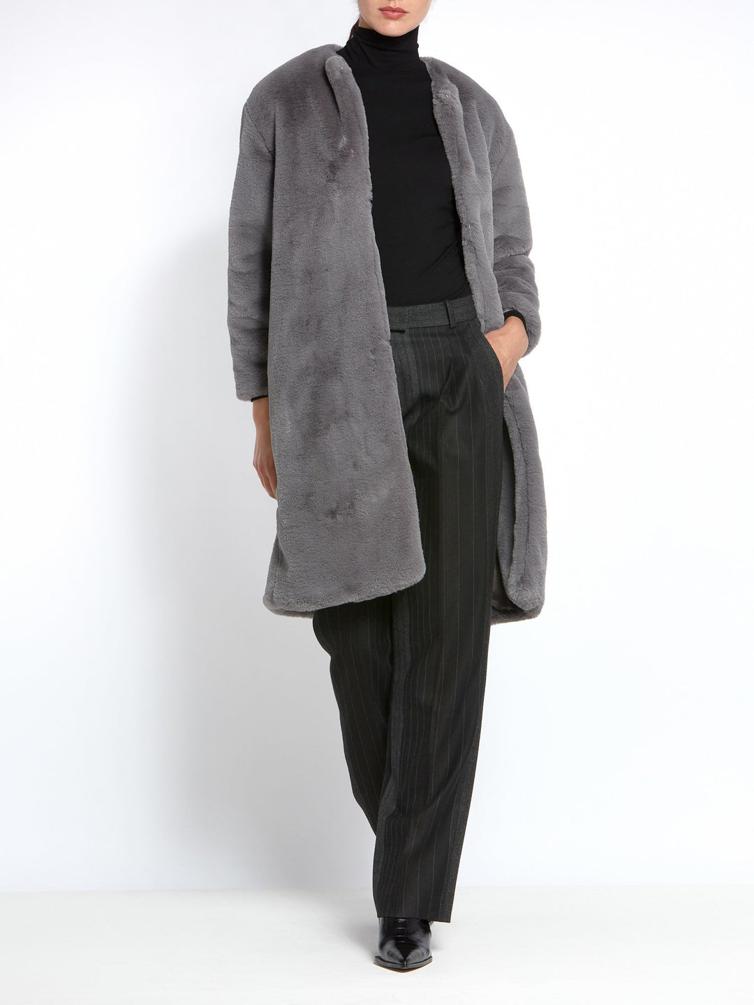 This Teddy coat gives instant style and warmth! A soft high pile faux fur in Silver grey. This Jewel neck loose-fitting silhouette with edge-to-edge fastening and dropped shoulder is a Winter must-have. Shrug this coat on over any outfit for an instant touch of glamour.