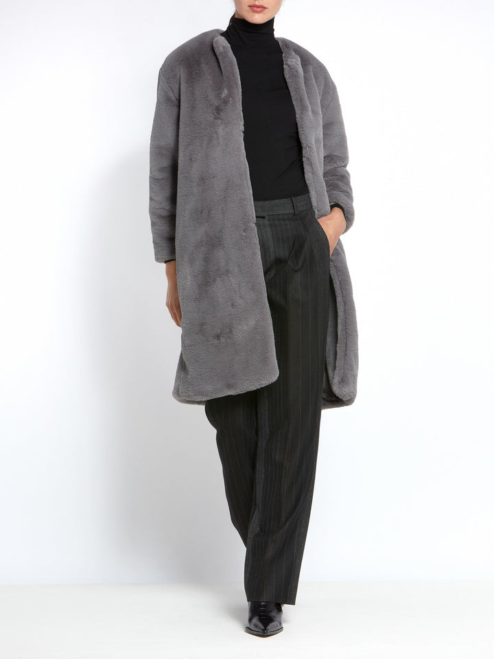 This Teddy coat gives instant style and warmth! A soft high pile faux fur in Silver grey. This Jewel neck loose-fitting silhouette with edge-to-edge fastening and dropped shoulder is a Winter must-have. Shrug this coat on over any outfit for an instant touch of glamour.