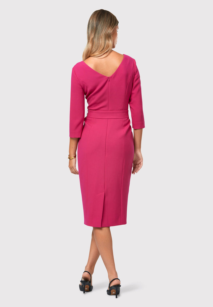 Introducing the Thea Cerise Pink Dress, a stunning reinterpretation of a classic Helen McAlinden silhouette. It features practical pockets, a detachable belt, and a pencil skirt that gracefully falls to a mid-calf length, allowing for a sophisticated and refined look. The inclusion of a back vent ensures ease of movement and comfort. Adding a new twist to the design, the dress showcases a feminine and romantic sweetheart neckline. 