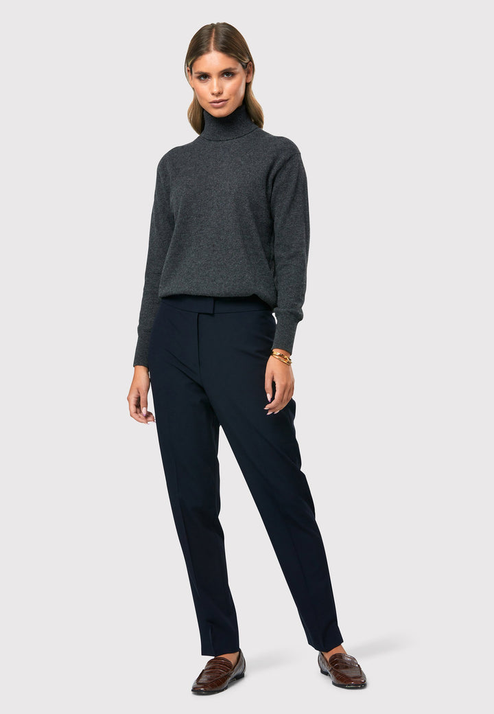 Introducing the Theresa Grey Cashmere Jumper, a luxurious and timeless wardrobe staple. This jumper features a tight roll-down polo neck, exuding sophistication and warmth. With full-length sleeves and tight ribbed cuffs and hem, it offers a comfortable and flattering fit. Crafted from soft and cozy cashmere, this jumper combines elegance and comfort effortlessly.