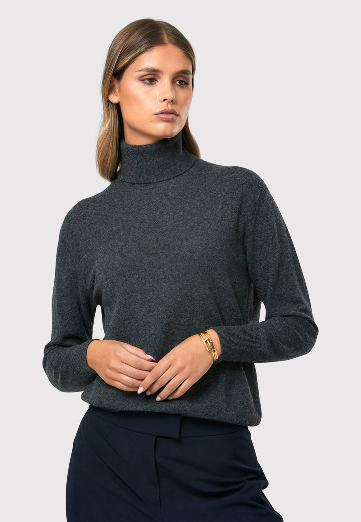 Introducing the Theresa Grey Cashmere Jumper, a luxurious and timeless wardrobe staple. This jumper features a tight roll-down polo neck, exuding sophistication and warmth. With full-length sleeves and tight ribbed cuffs and hem, it offers a comfortable and flattering fit. Crafted from soft and cozy cashmere, this jumper combines elegance and comfort effortlessly.