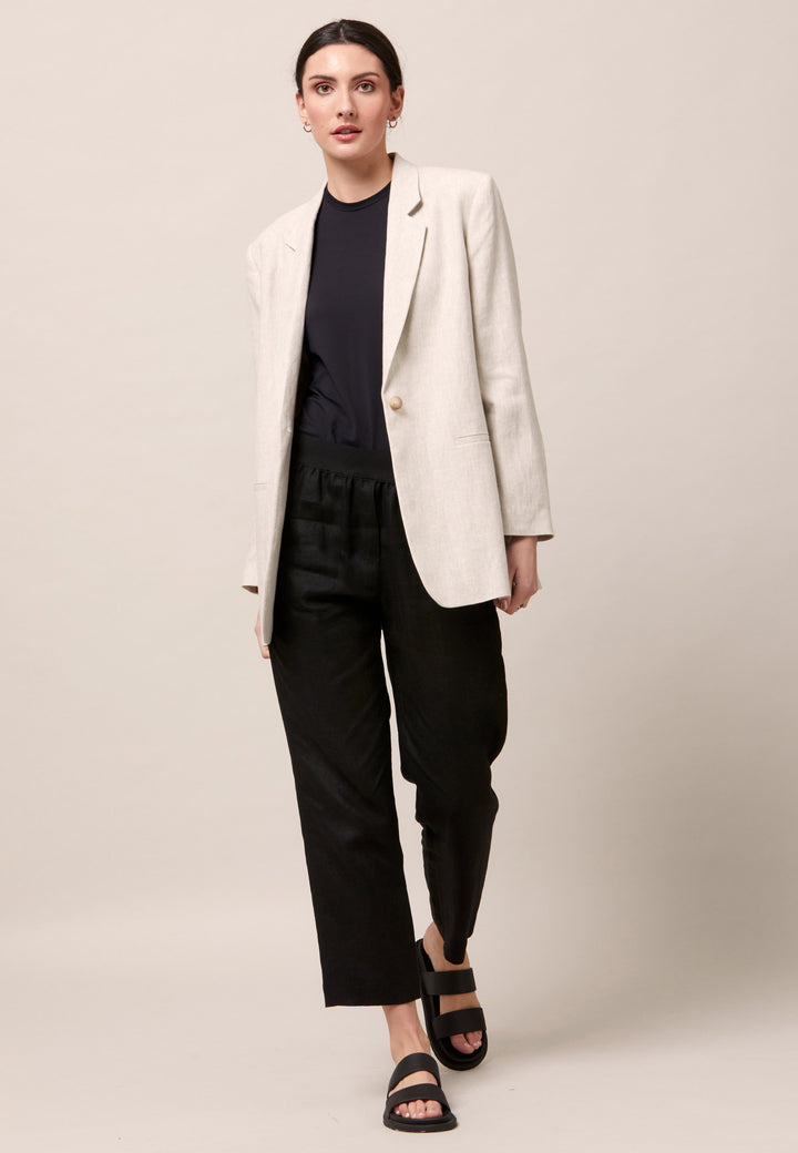Choose the Vanessa black pant. A loose-fitting, pull-on linen pant that embraces laid-back spirit. A piece you can't travel without. Designed to sit on the high waist for a flattering fit. Features an elasticated waistband. Pair it with a simple tee and the co-ordinating Cassie boyfriend-blazer with trainers for a chic and contemporary look.