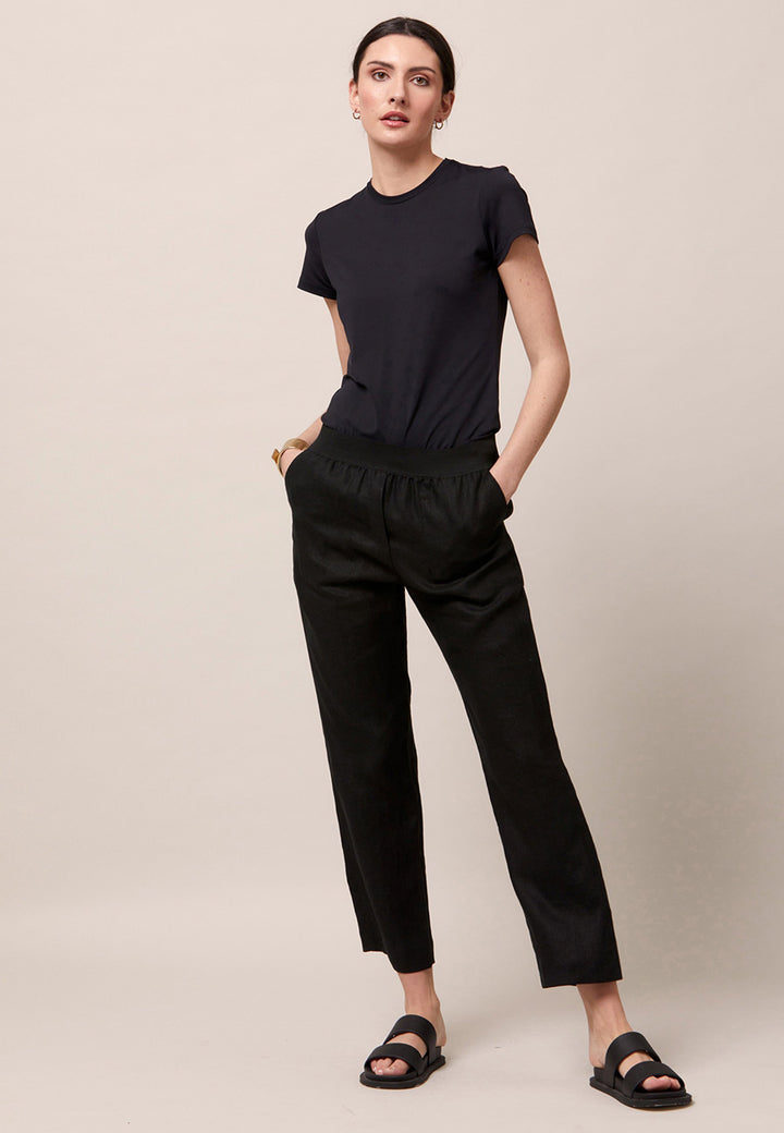 Choose the Vanessa black pant. A loose-fitting, pull-on linen pant that embraces laid-back spirit. A piece you can't travel without. Designed to sit on the high waist for a flattering fit. Features an elasticated waistband. Pair it with a simple tee and the co-ordinating Cassie boyfriend-blazer with trainers for a chic and contemporary look.