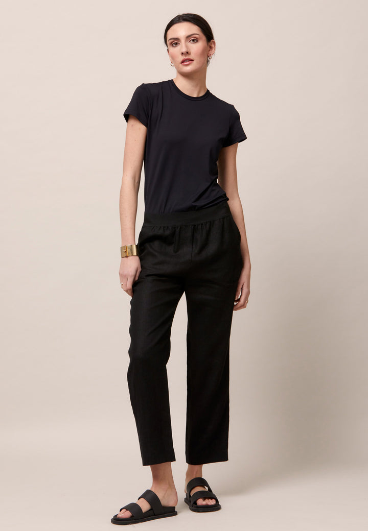 Choose the Vanessa black pant. A loose-fitting, pull-on linen pant that embraces laid-back spirit. A piece you can't travel without. Designed to sit on the high waist for a flattering fit. Features an elasticated waistband. Pair it with a simple tee and the co-ordinating Cassie boyfriend-blazer with trainers for a chic and contemporary look.