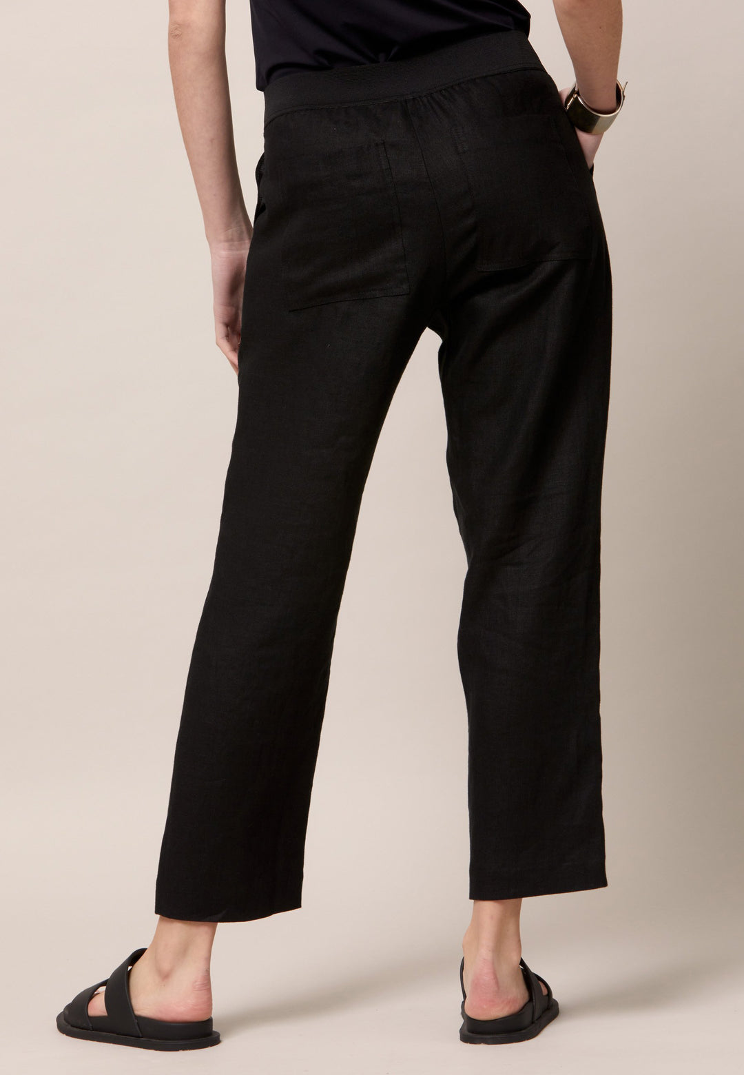 Choose the Vanessa black pant. A loose-fitting, pull-on linen pant that embraces laid-back spirit. A piece you can't travel without. Designed to sit on the high waist for a flattering fit. Features an elasticated waistband. Pair it with a simple tee and the co-ordinating Cassie boyfriend-blazer with trainers for a chic and contemporary look.