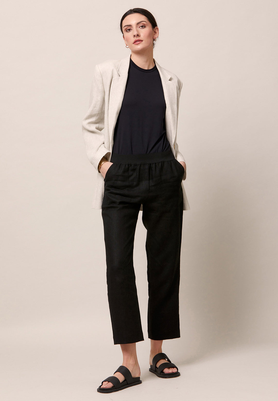 Choose the Vanessa black pant. A loose-fitting, pull-on linen pant that embraces laid-back spirit. A piece you can't travel without. Designed to sit on the high waist for a flattering fit. Features an elasticated waistband. Pair it with a simple tee and the co-ordinating Cassie boyfriend-blazer with trainers for a chic and contemporary look.