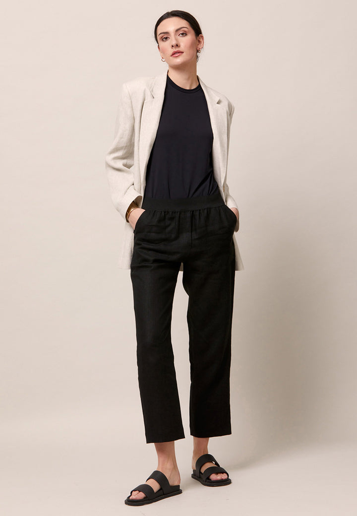 Choose the Vanessa black pant. A loose-fitting, pull-on linen pant that embraces laid-back spirit. A piece you can't travel without. Designed to sit on the high waist for a flattering fit. Features an elasticated waistband. Pair it with a simple tee and the co-ordinating Cassie boyfriend-blazer with trainers for a chic and contemporary look.