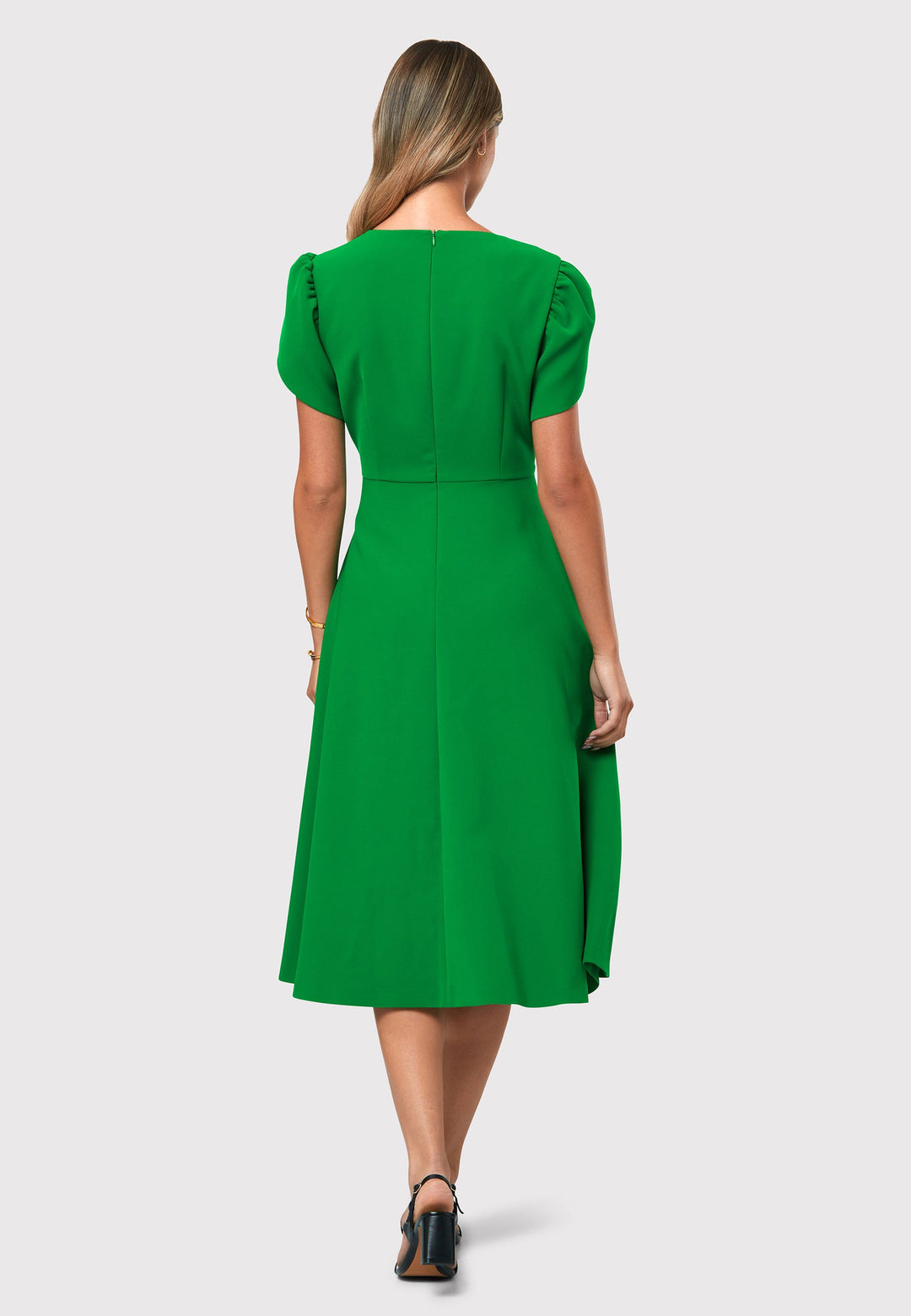 Introducing the Vera Kelly Green Dress, a captivating fit and flare ensemble that effortlessly combines timeless elegance with modern charm. This dress boasts an A-line skirt that creates a graceful and feminine silhouette, while its detailed overlap short sleeves add a unique and stylish touch to the design. With its form-flattering fit, this dress accentuates your curves in all the right places, making it perfect for weddings and other special occasions. 