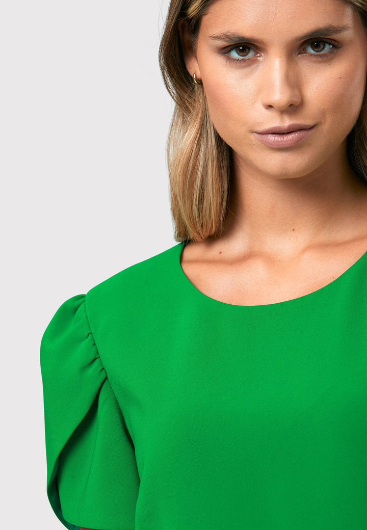 Introducing the Vera Kelly Green Dress, a captivating fit and flare ensemble that effortlessly combines timeless elegance with modern charm. This dress boasts an A-line skirt that creates a graceful and feminine silhouette, while its detailed overlap short sleeves add a unique and stylish touch to the design. With its form-flattering fit, this dress accentuates your curves in all the right places, making it perfect for weddings and other special occasions. 