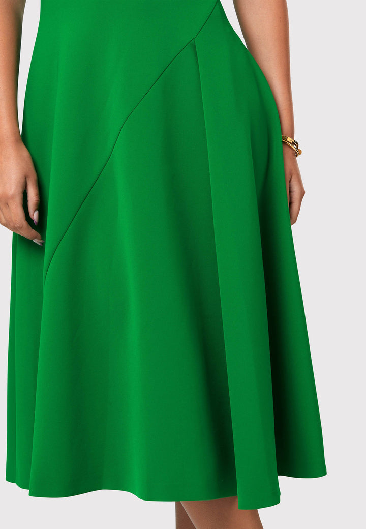 Introducing the Vera Kelly Green Dress, a captivating fit and flare ensemble that effortlessly combines timeless elegance with modern charm. This dress boasts an A-line skirt that creates a graceful and feminine silhouette, while its detailed overlap short sleeves add a unique and stylish touch to the design. With its form-flattering fit, this dress accentuates your curves in all the right places, making it perfect for weddings and other special occasions. 