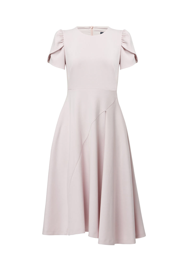 The Vera Soft Pink Dress is a captivating fit-and-flare piece. This feminine round-neck dress showcases a flared skirt that falls to a flattering mid-calf length, complete with practical pockets. The sleeves are adorned with intricate overlapping details, adding a unique touch of interest.