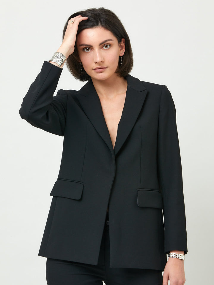 Willow, redefining the blazer. This modern blazer features a classic collar and rever, semi-fitted silhouette cut from timeless black double crepe with a hint of stretch to give a sense of ease.