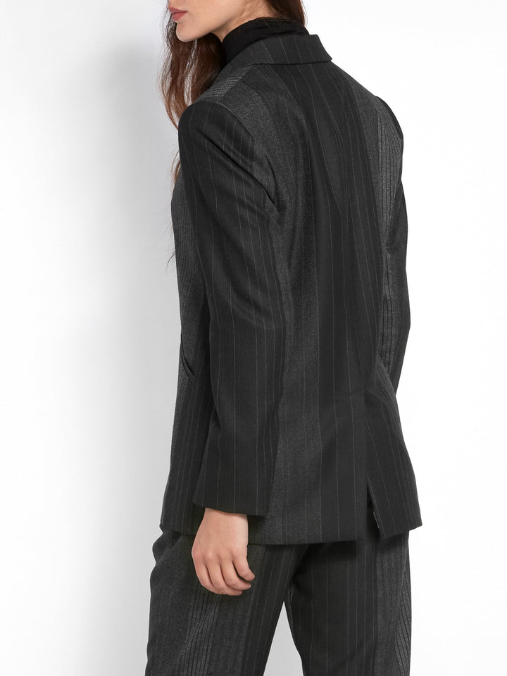 Think Diane Keaton in Manhattan. An elegant jacket fabricated in an androgynous random monotone stripe. A Classic Semi-Fitted silhouette with lapel collar, jeet pockets, lined & tailored with a one-button fastening. Helen proses to style with the co-ordinating Sophie pant & Cora polo-neck top.